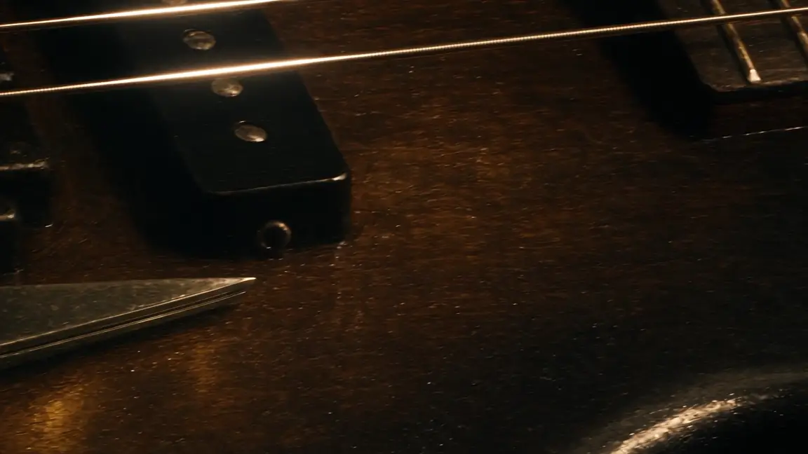 Real barber shears lying on the body of a four-string bass
