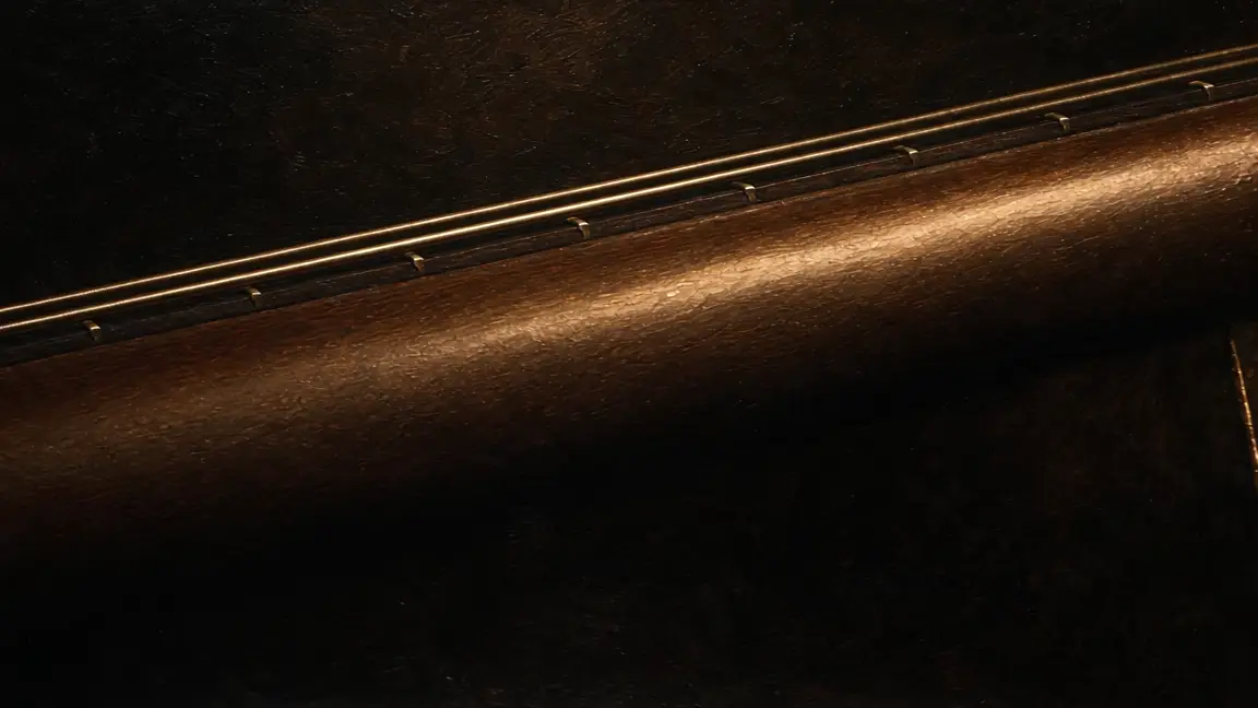 The wooden neck becoming the leather arm of the chair